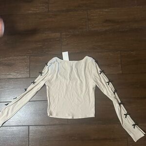 Elegant Cream Top with Black Bow Accents